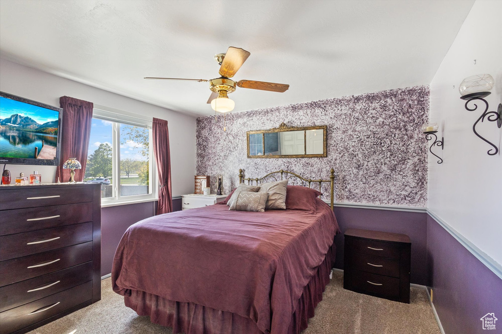 Bedroom featuring ceiling fan and carpet floors