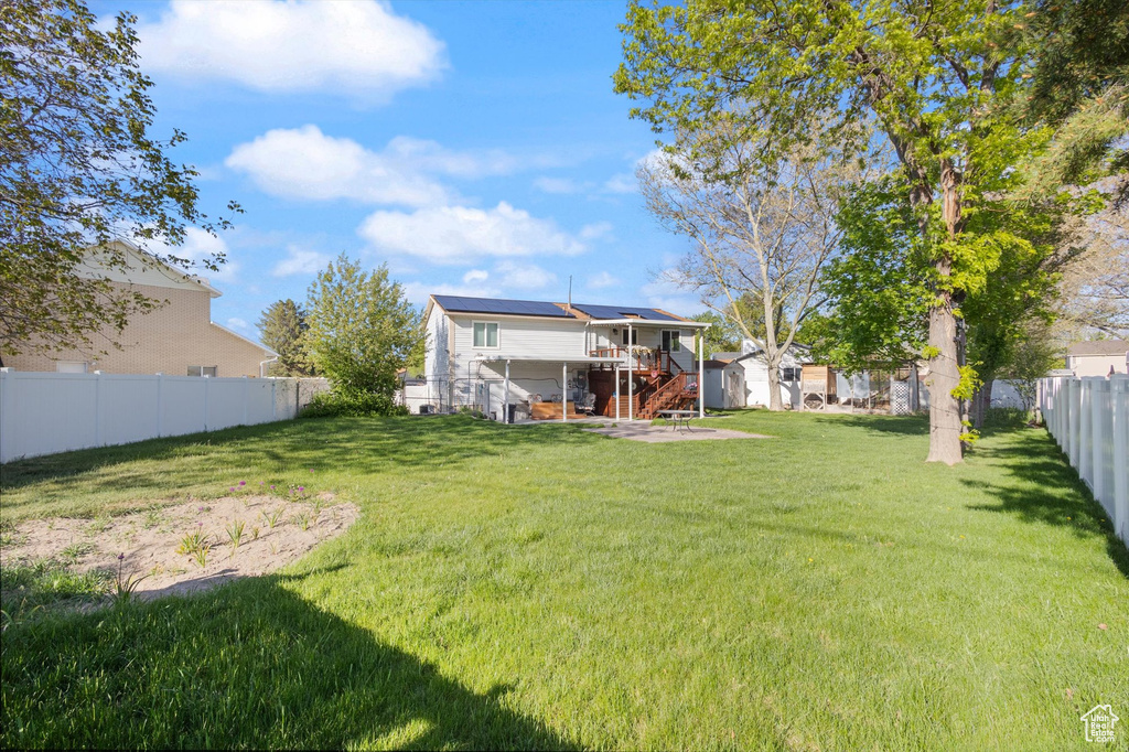 View of yard featuring an outbuilding, stairway, a fenced backyard, and a shed