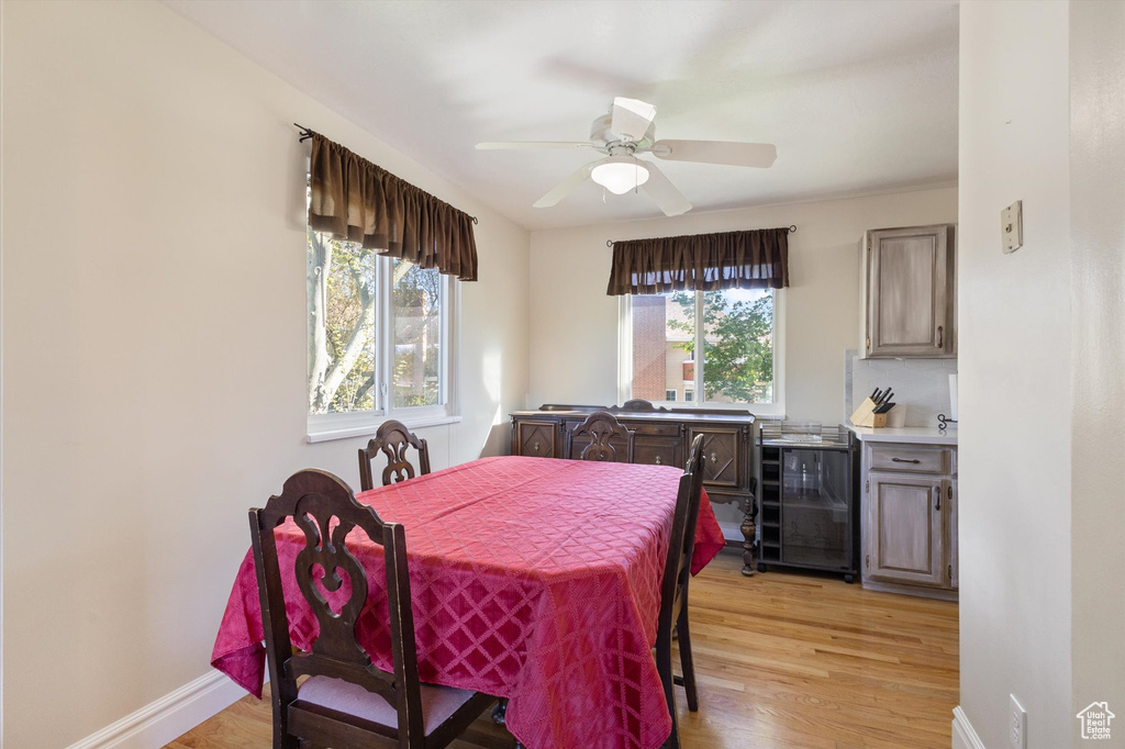 Dining area with wine cooler, a wealth of natural light, and light wood-style floors