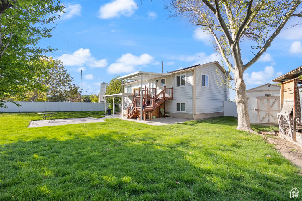 Rear view of house with fence, a patio area, stairs, and a shed
