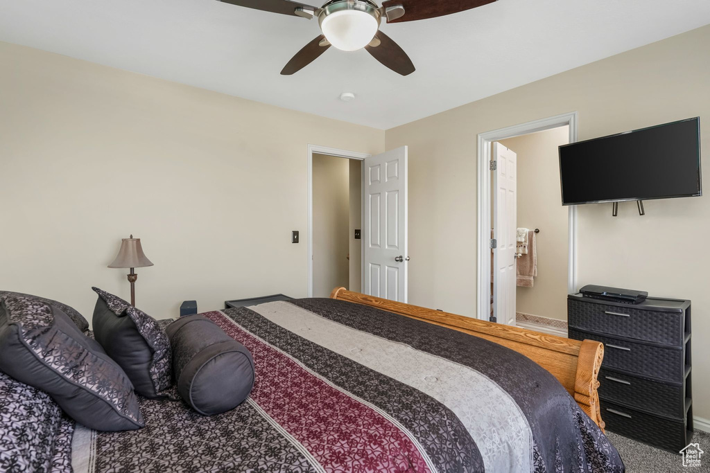 Bedroom featuring carpet flooring, connected bathroom, baseboards, and ceiling fan