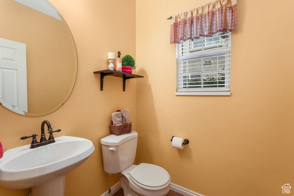 Bathroom with a sink, toilet, and baseboards