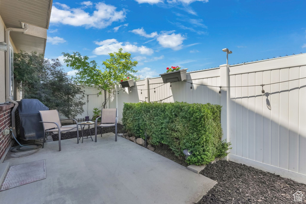 View of patio featuring fence
