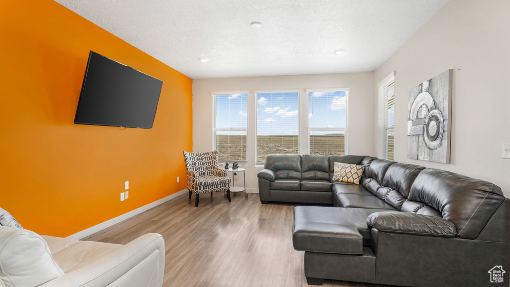 Living area featuring baseboards and wood finished floors