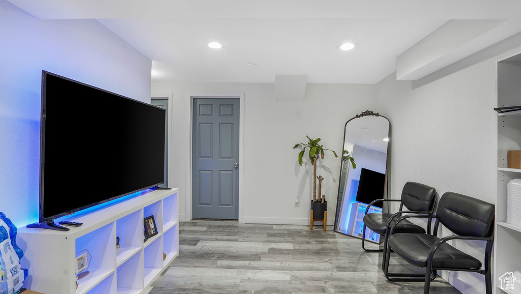 Living area featuring baseboards, recessed lighting, and light wood-style flooring