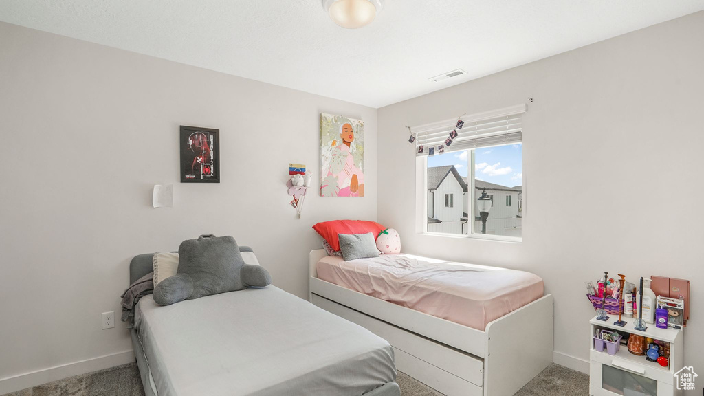 Bedroom with visible vents, baseboards, and carpet floors