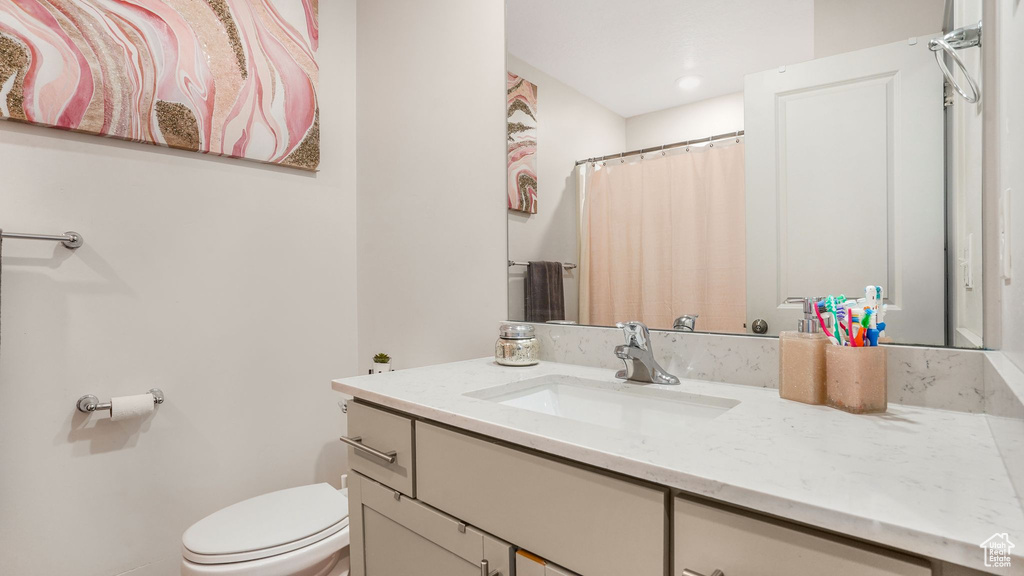 Full bathroom featuring vanity and toilet