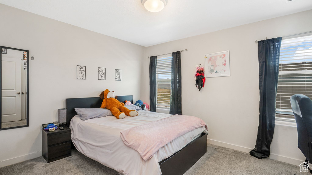 Bedroom with carpet flooring and baseboards