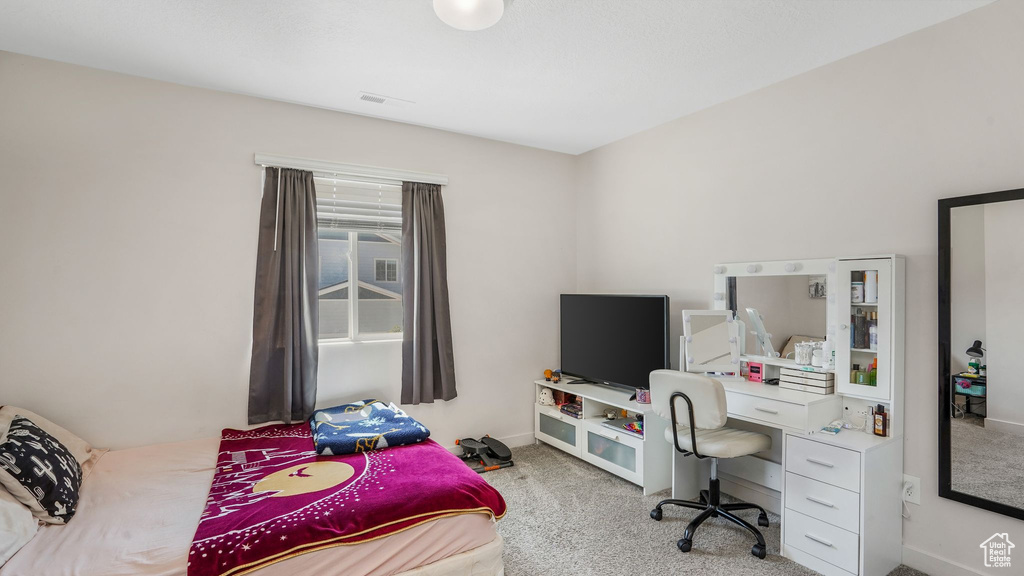 Bedroom with carpet floors, baseboards, and visible vents