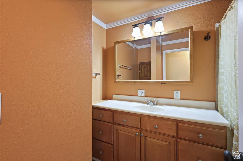 Bathroom featuring vanity and ornamental molding