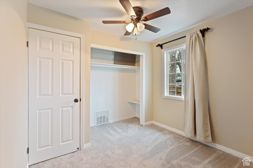 Unfurnished bedroom with baseboards, a closet, visible vents, and carpet floors