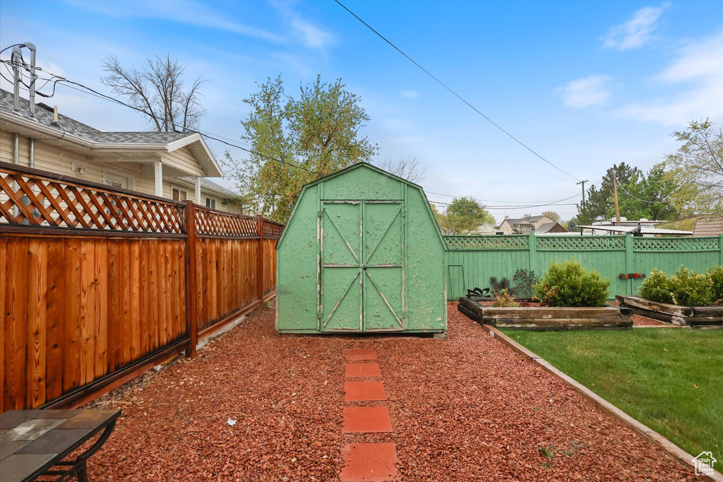 View of shed with a fenced backyard