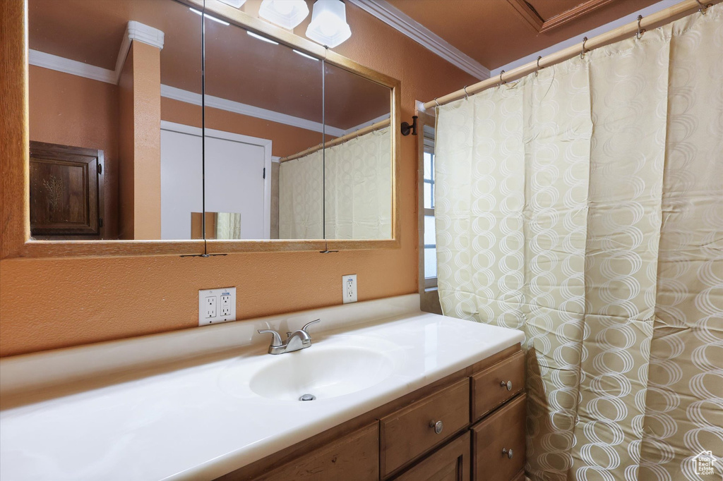 Bathroom featuring vanity and ornamental molding