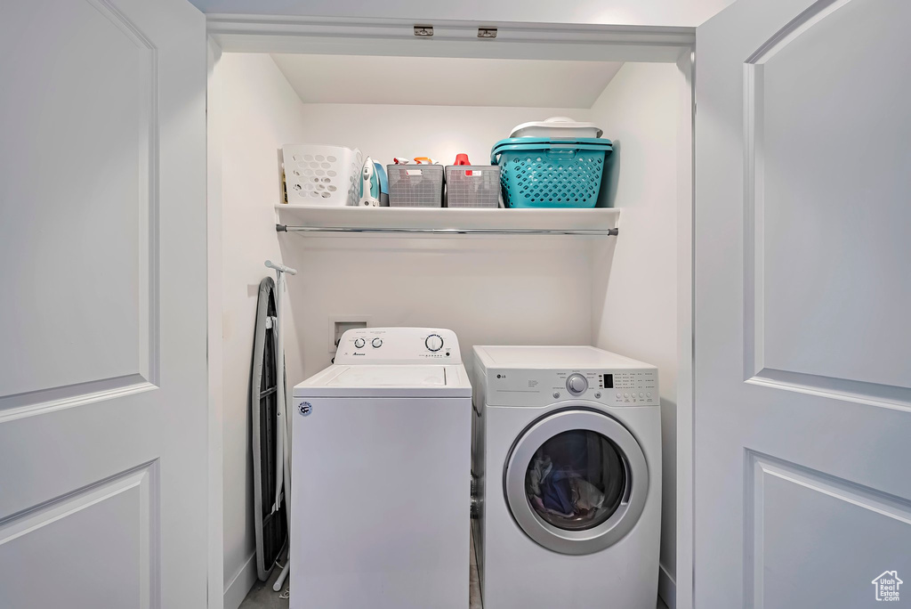 Laundry area featuring independent washer and dryer and laundry area