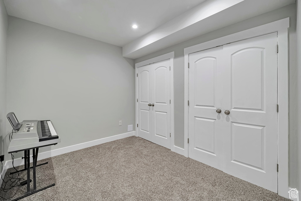 Interior space with baseboards, carpet flooring, and recessed lighting