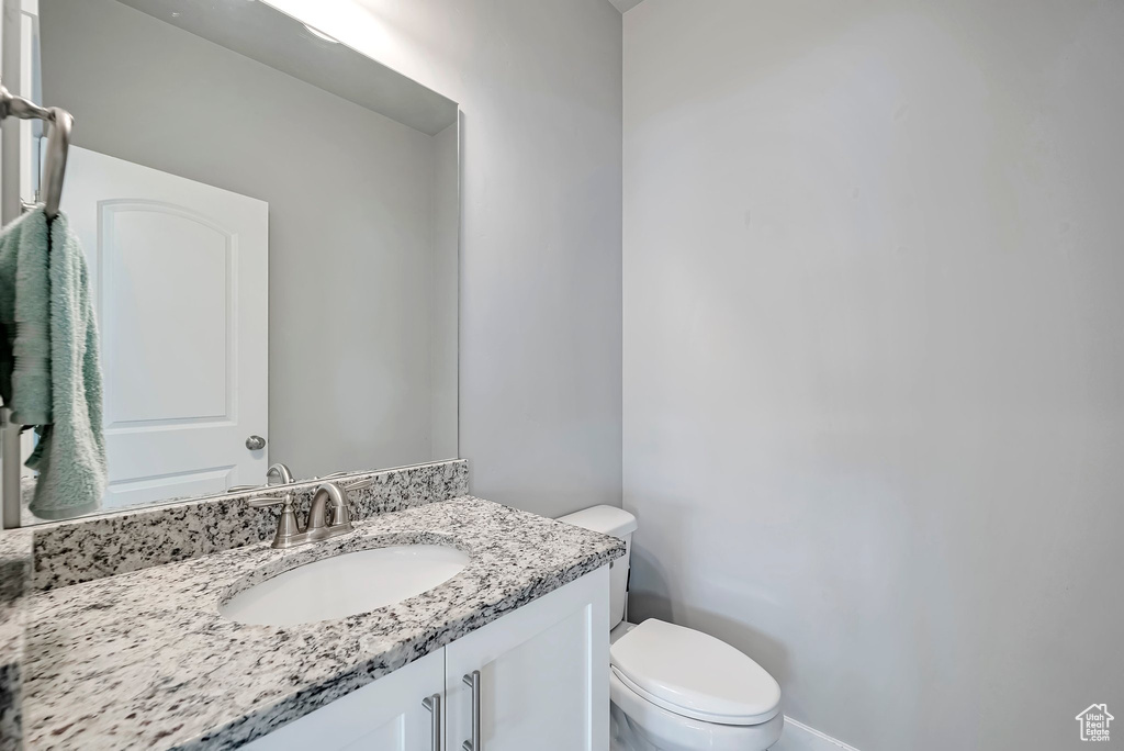 Half bath featuring vanity and toilet