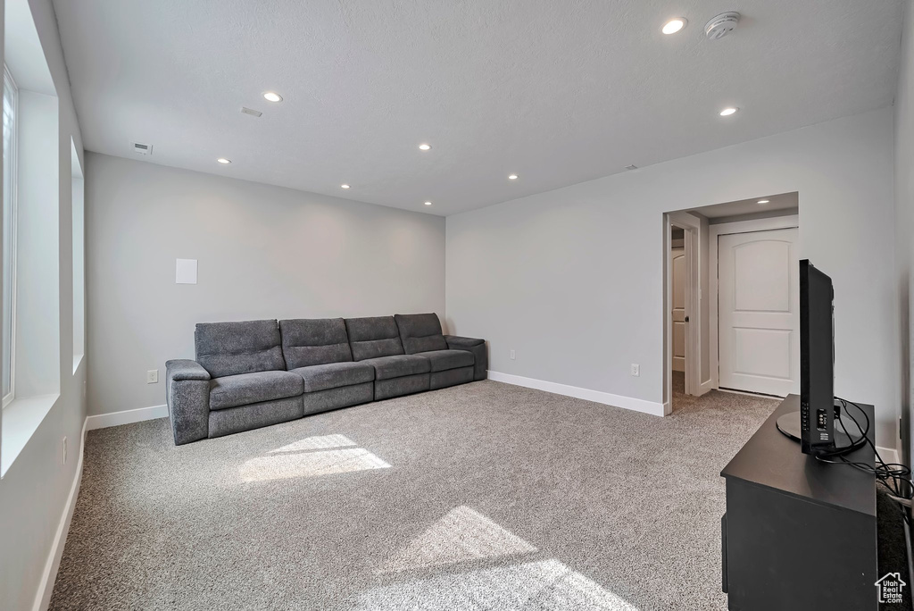 Unfurnished living room with recessed lighting, carpet, baseboards, and visible vents