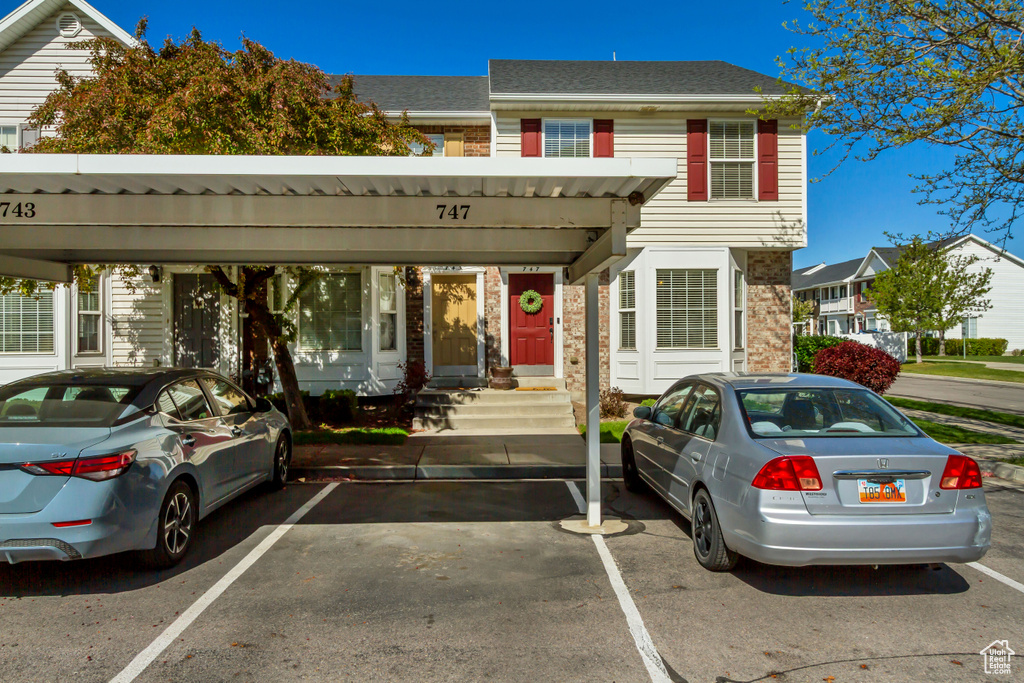 Multi unit property with covered and uncovered parking and brick siding