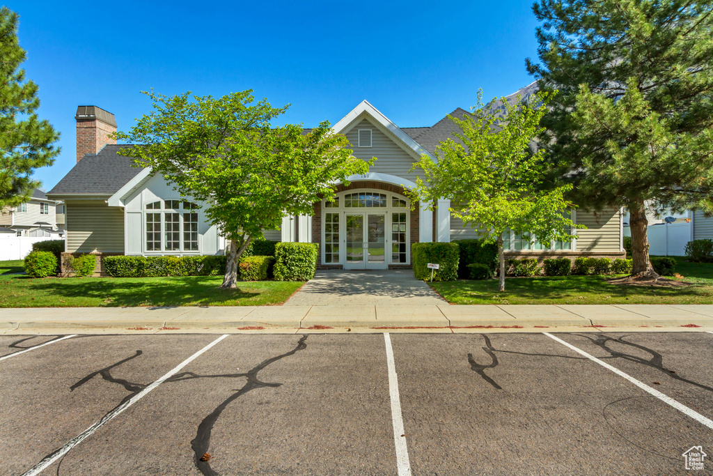 View of property featuring uncovered parking