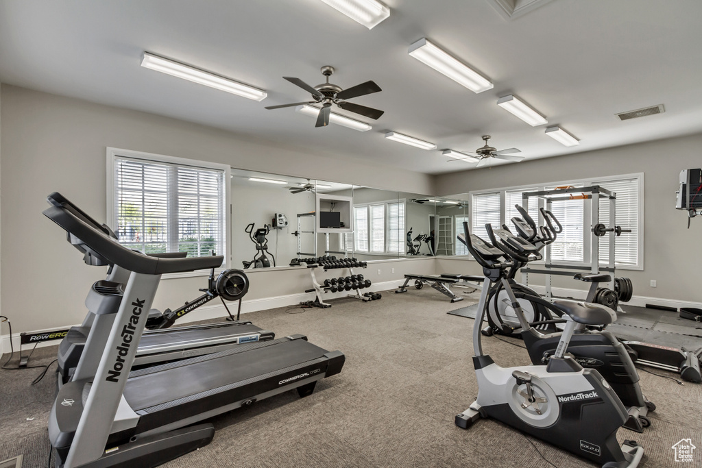 Workout area featuring visible vents, baseboards, and a ceiling fan