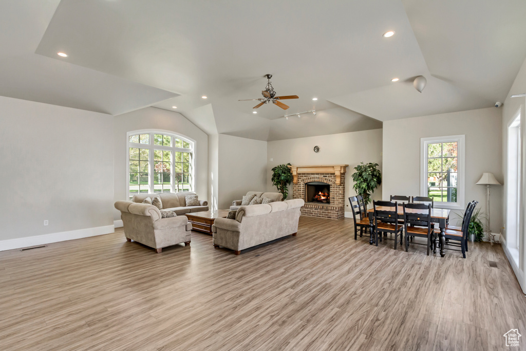 Living area with ceiling fan, recessed lighting, a healthy amount of sunlight, and light wood-style floors