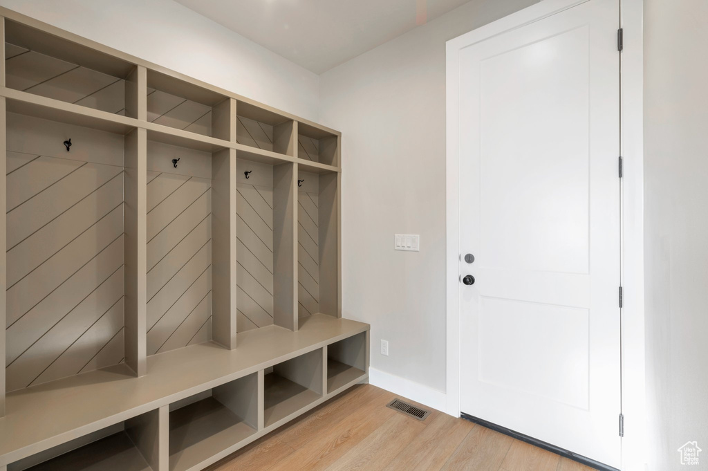 Mudroom featuring baseboards, light wood-style flooring, and visible vents