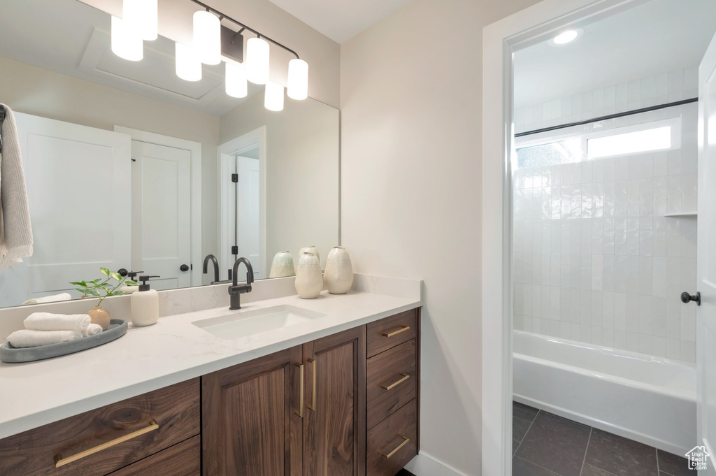 Bathroom featuring vanity, baseboards, bathing tub / shower combination, and tile patterned floors