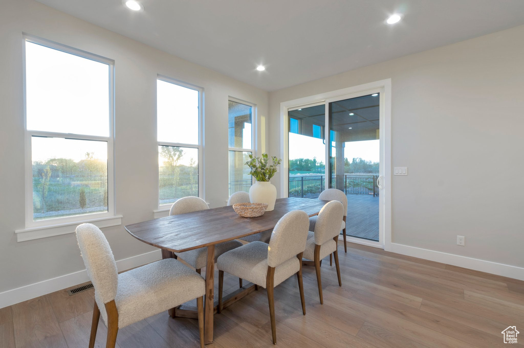Dining space featuring light wood finished floors, visible vents, baseboards, and recessed lighting