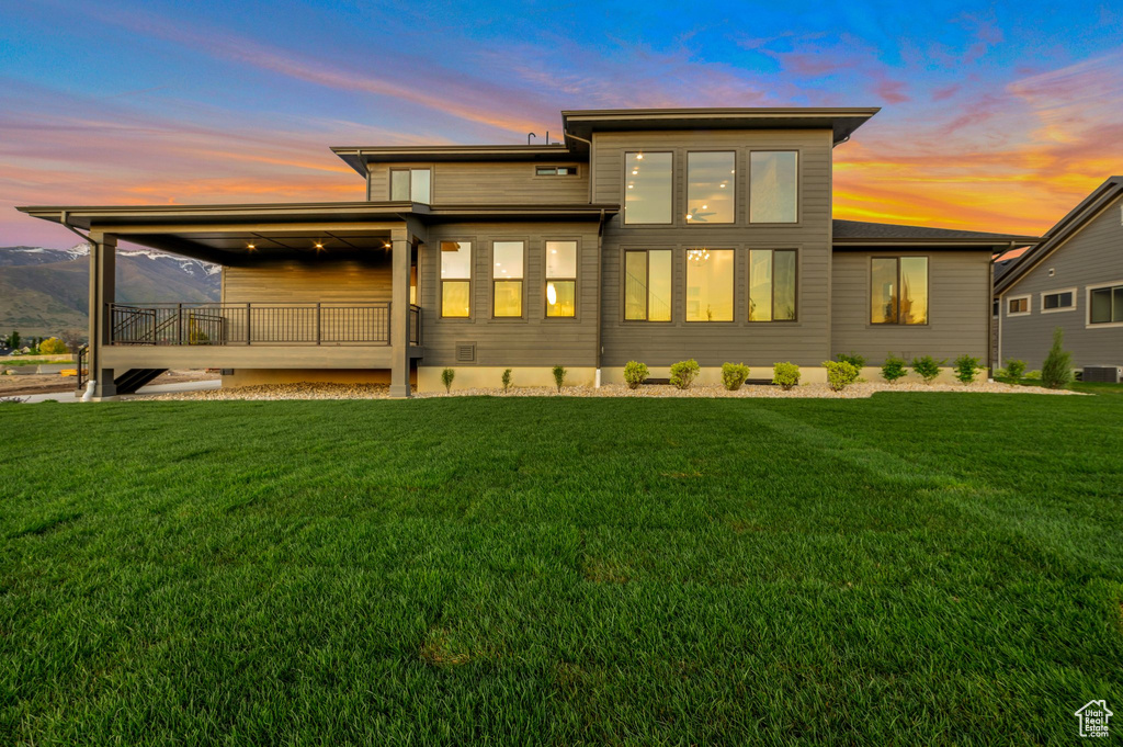 Rear view of house with a lawn