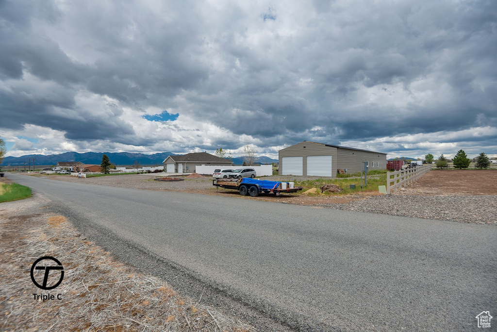 View of asphalt street featuring a mountain view