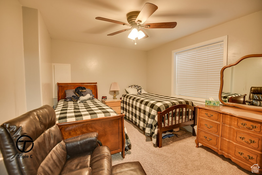 Bedroom featuring light carpet and a ceiling fan