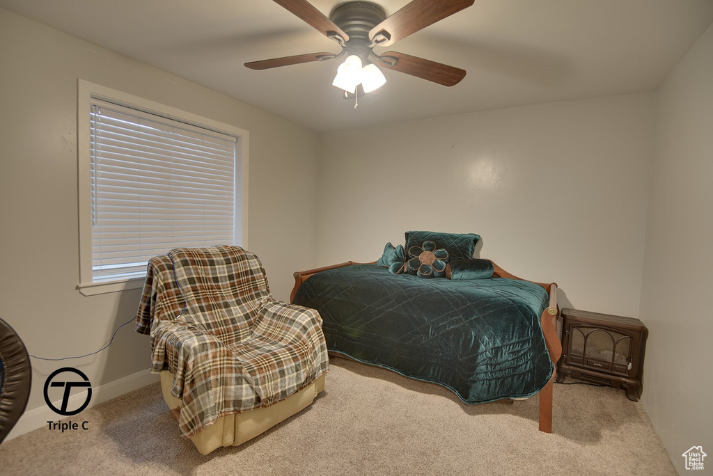 Carpeted bedroom with baseboards and ceiling fan
