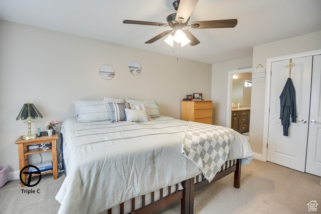 Bedroom featuring baseboards, light carpet, a closet, and ceiling fan