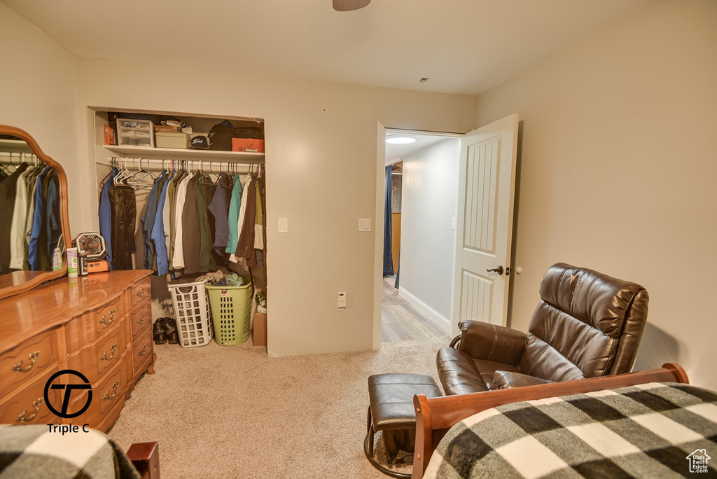 Bedroom with a closet and light colored carpet