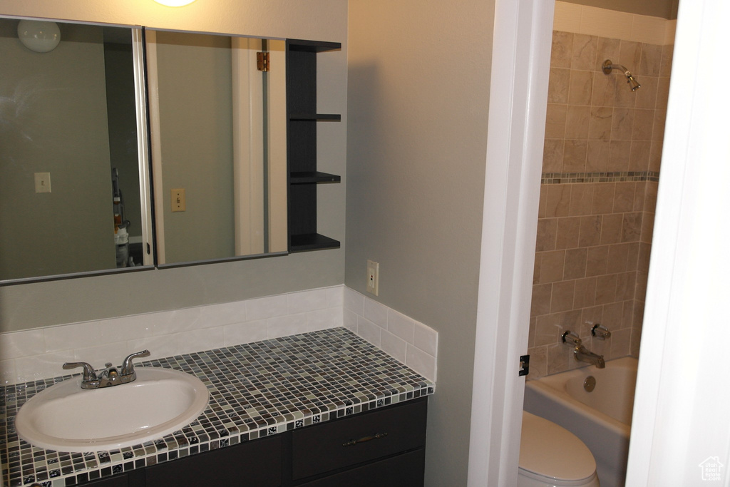 Full bath featuring toilet, bathing tub / shower combination, and vanity