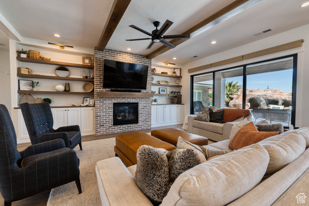 Living room with visible vents, a fireplace, beamed ceiling, ceiling fan, and recessed lighting
