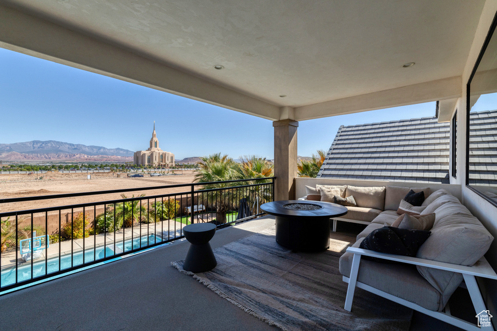 Wooden deck with a mountain view and an outdoor living space with a fire pit