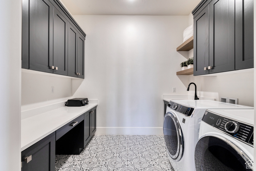 Washroom with washer and dryer, baseboards, a sink, cabinet space, and light tile patterned floors