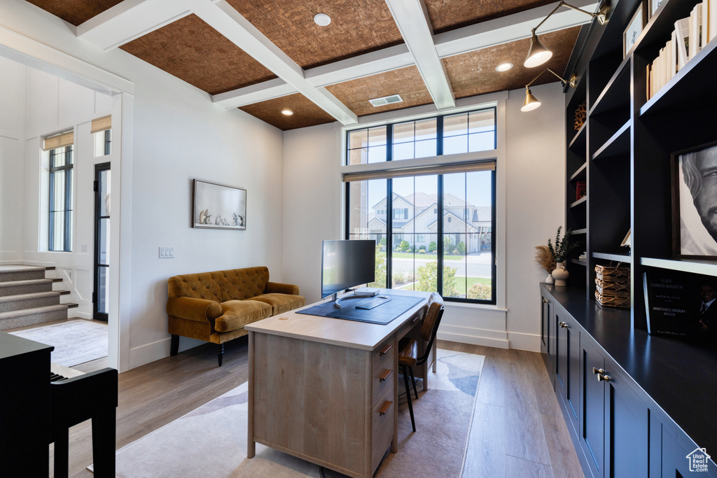Home office with baseboards, coffered ceiling, and light wood-type flooring