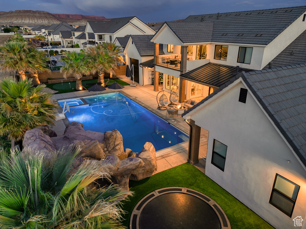 Outdoor pool with a fenced backyard, a patio, and a residential view
