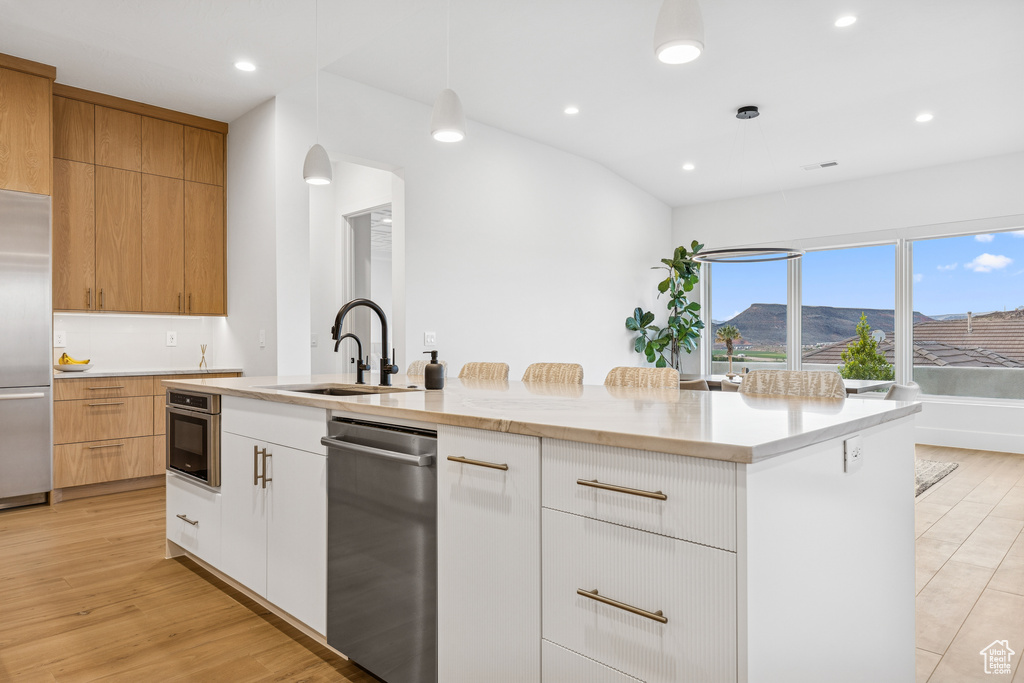 Kitchen featuring a sink, recessed lighting, modern cabinets, and appliances with stainless steel finishes