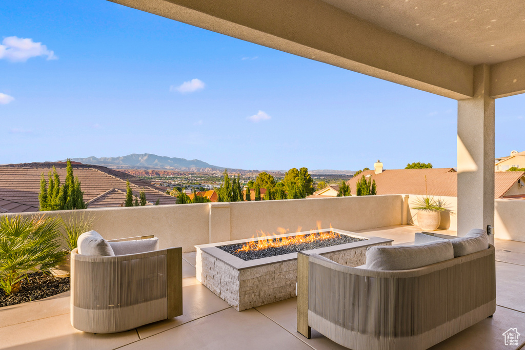 View of patio featuring an outdoor living space with a fire pit and a mountain view