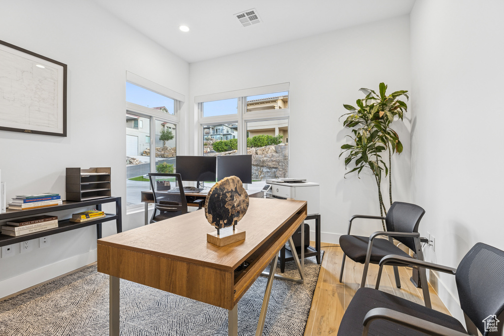 Home office with light wood-type flooring, visible vents, baseboards, and recessed lighting