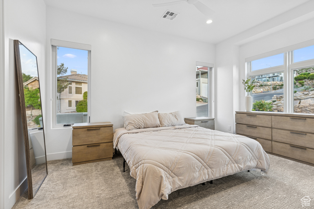 Bedroom featuring visible vents, baseboards, ceiling fan, light colored carpet, and recessed lighting