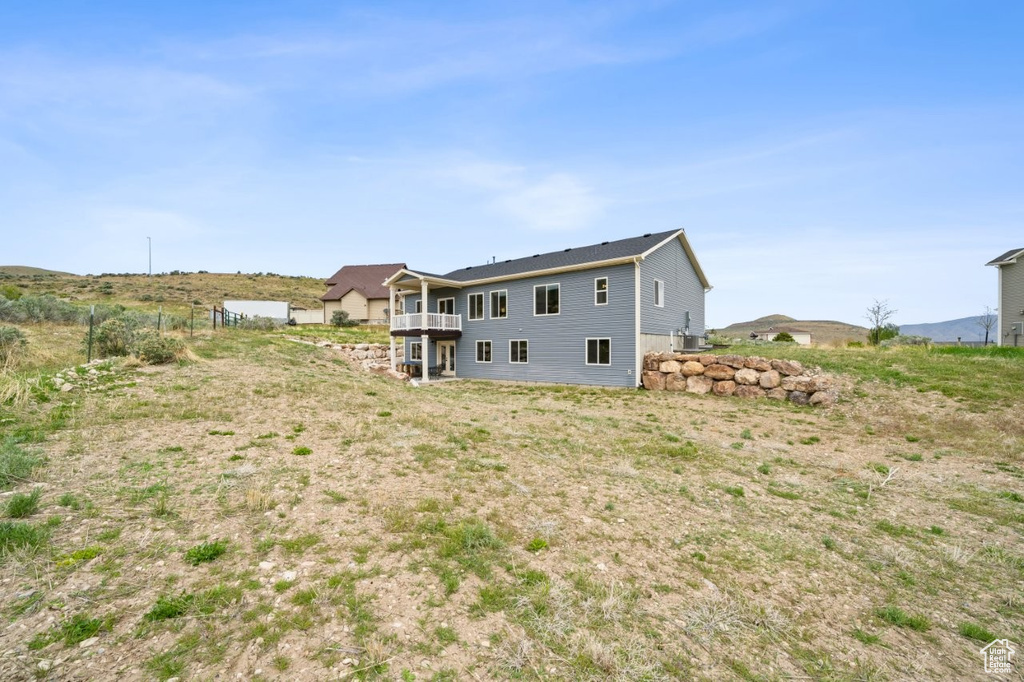 Back of house featuring a balcony