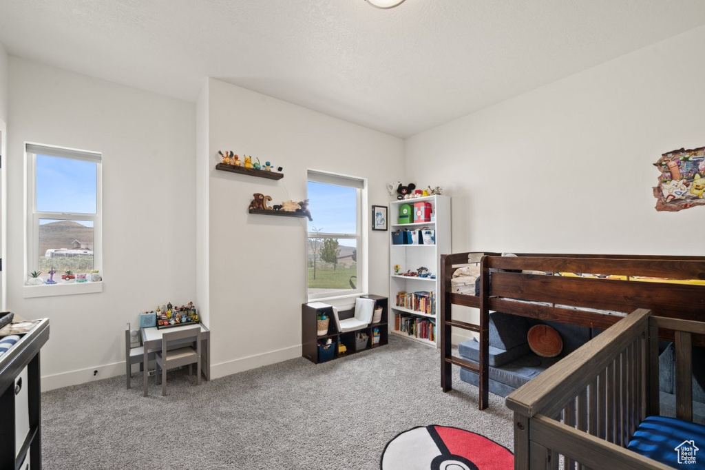 Bedroom featuring carpet flooring, multiple windows, and baseboards