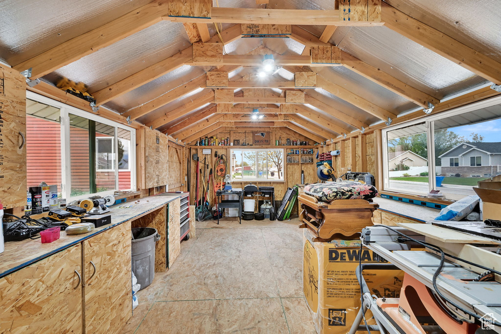 Interior space with vaulted ceiling and a workshop area