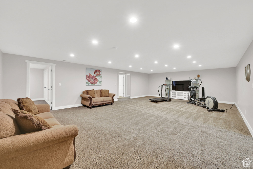 Carpeted living area featuring baseboards and recessed lighting
