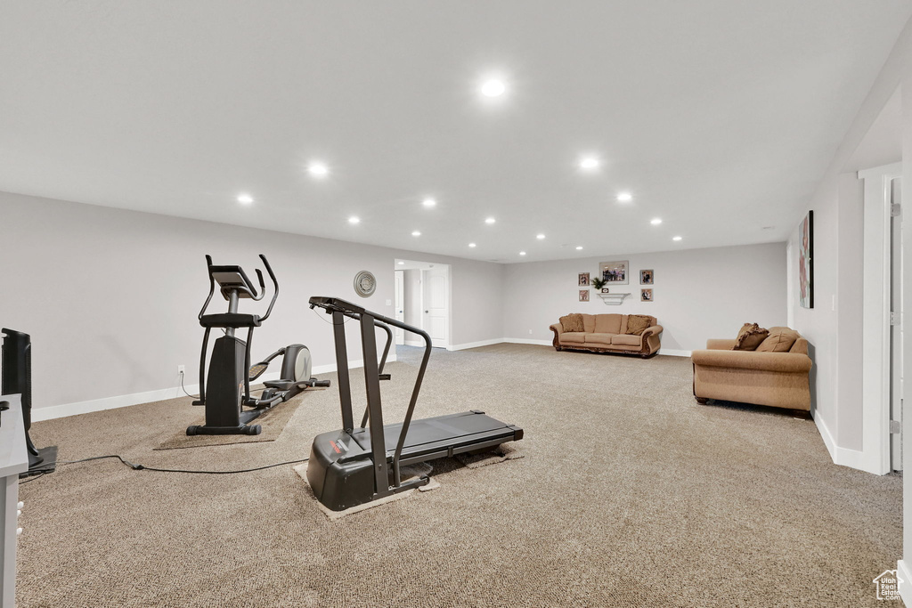 Exercise area featuring carpet floors, baseboards, and recessed lighting