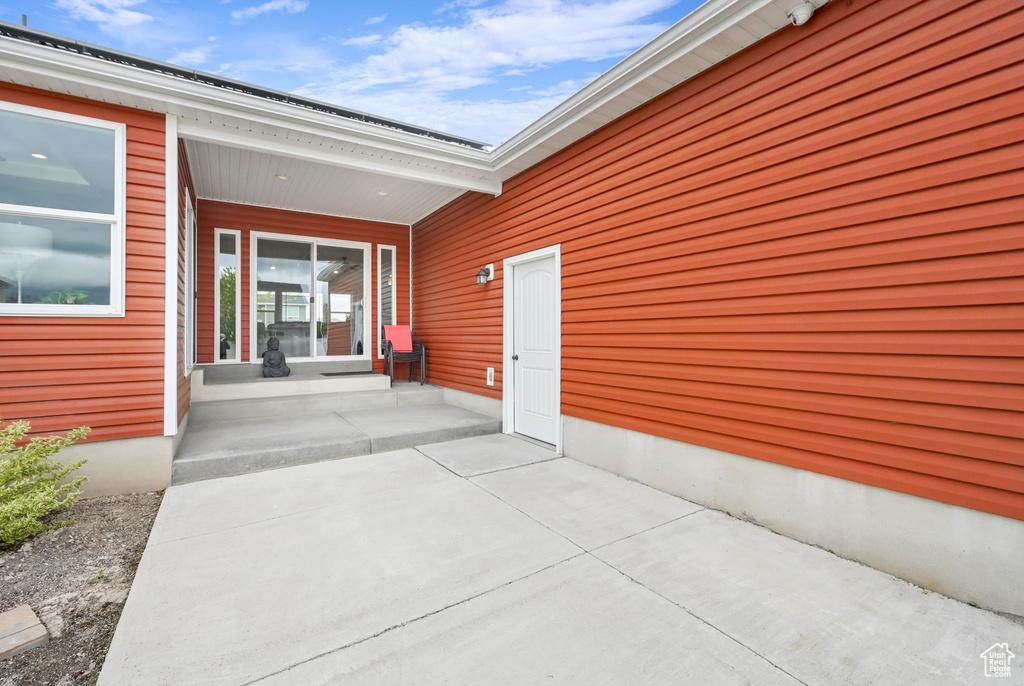 View of exterior entry with a porch